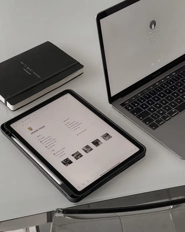 Modern workspace with iPad displaying a project dashboard, MacBook, and notebook on a glass desk freelance digital marketing expert in Calicut, Kerala